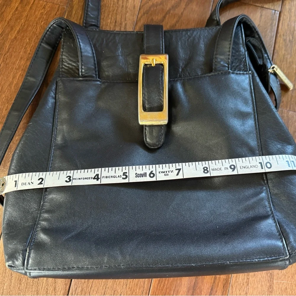 Laura Scott Black shoulder bag with front and back outer pockets, snap closure.